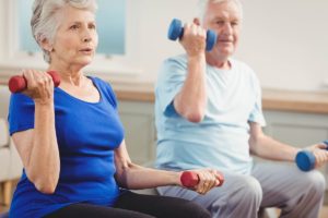 seniors lifting weights during Senior Living Health Programs in garland tx