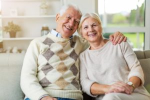 senior man and woman on a couch learning about Residential Senior Living Options